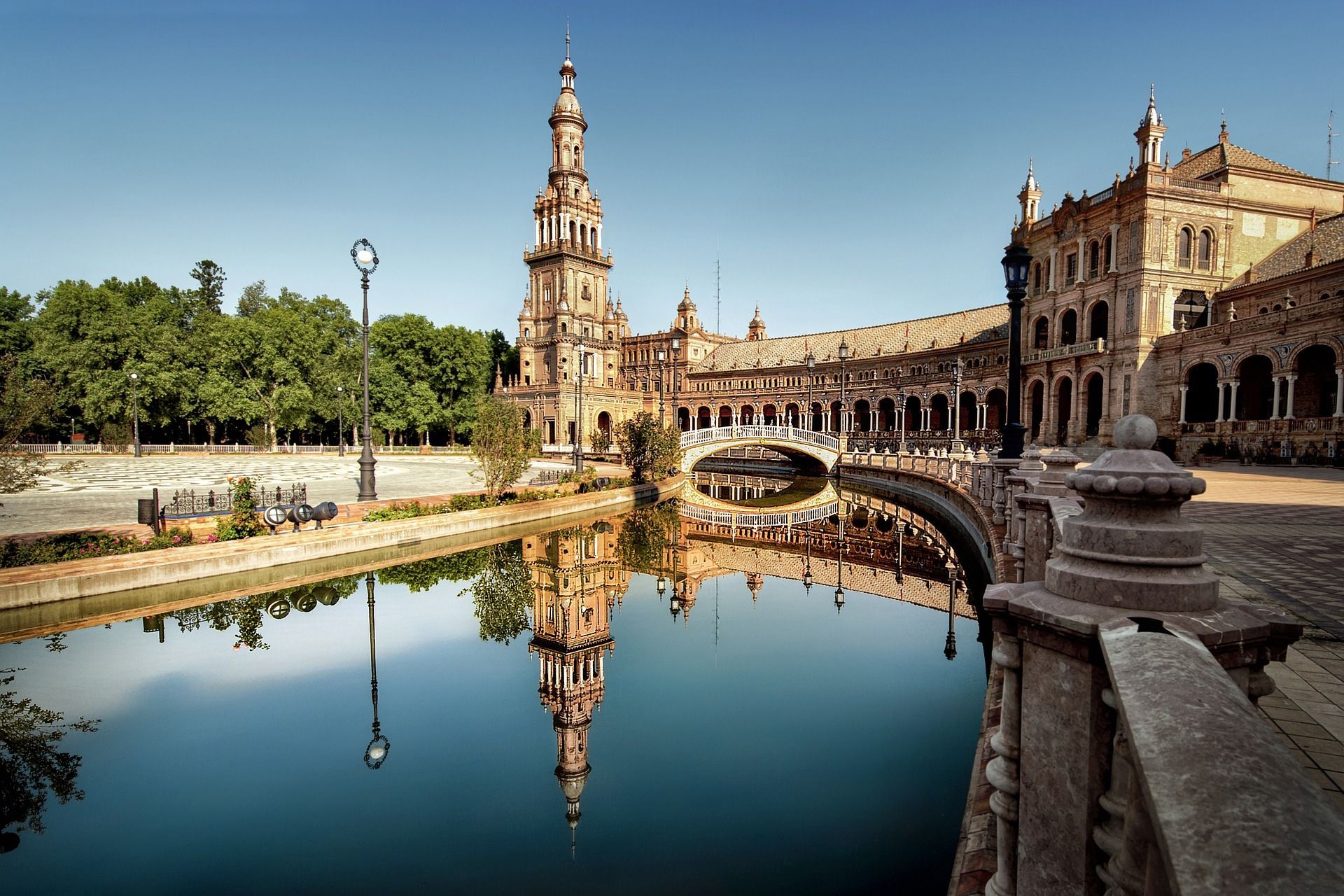 A large building is reflected in a body of water