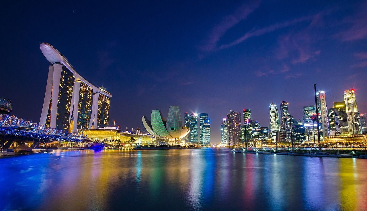 Singapore city skyline at night with a large body of water in the foreground  on Azamara 2027 World Cruise