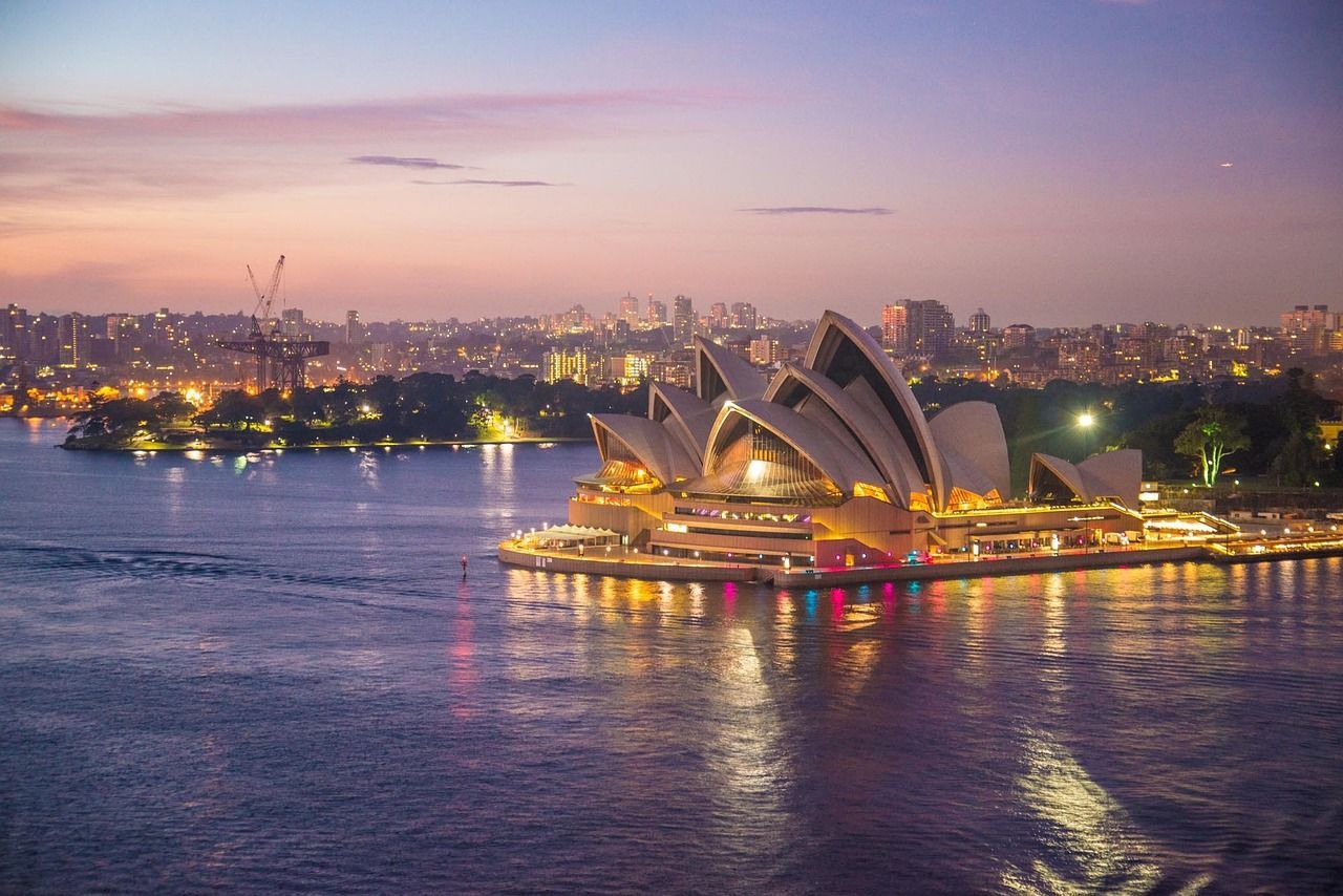 An aerial view of the opera house in sydney at night  on Azamara 2027 World Cruise