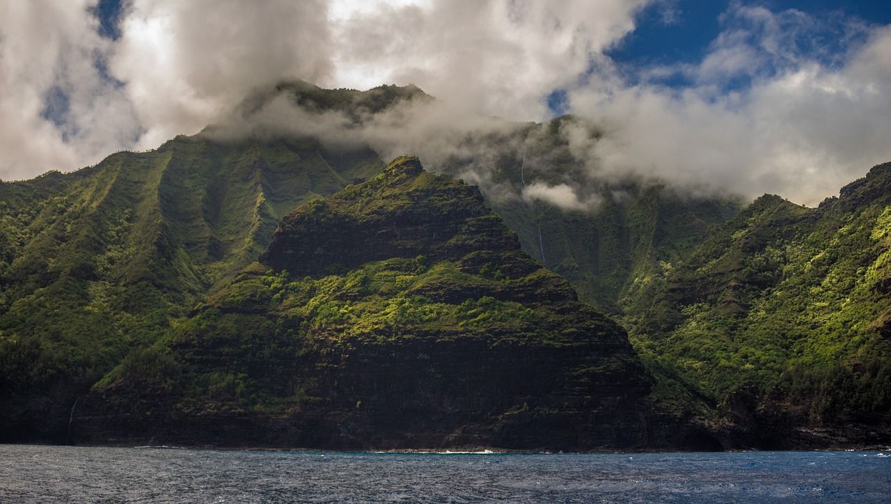 There are mountains in the background and a body of water in the foreground.