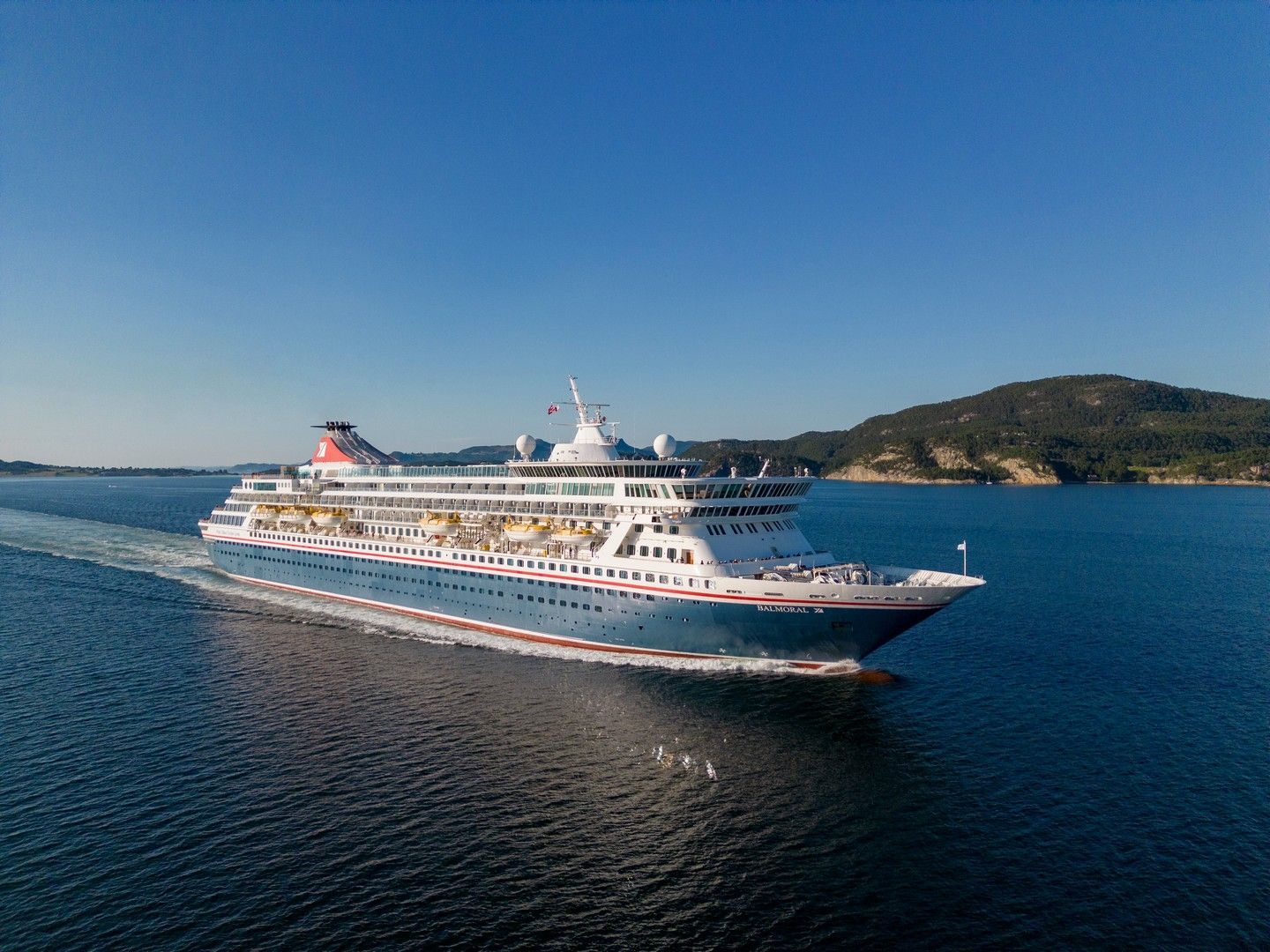 An aerial view of a cruise ship floating on top of a body of water.