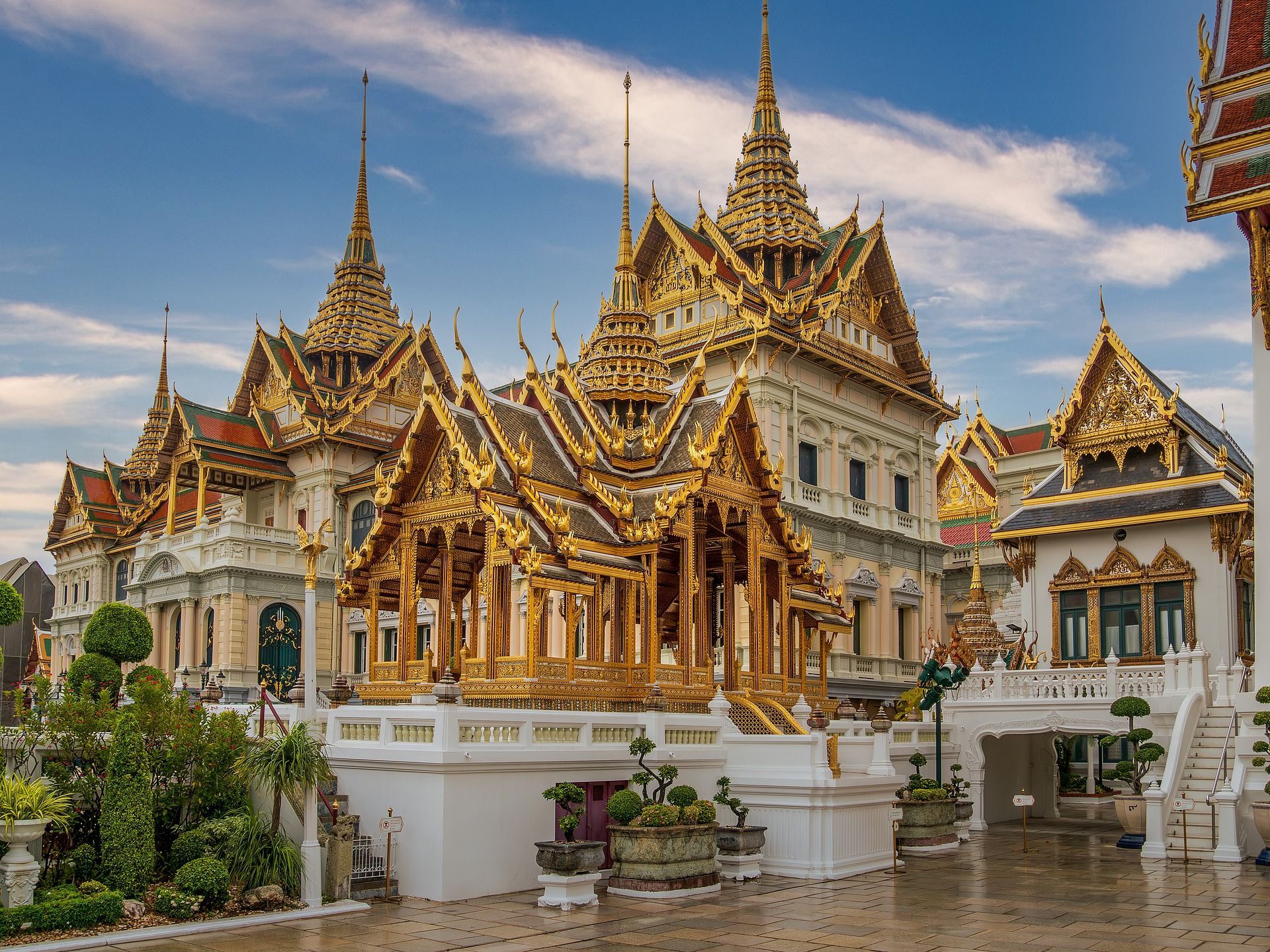 A large building with a lot of gold decorations on it in Bangkok