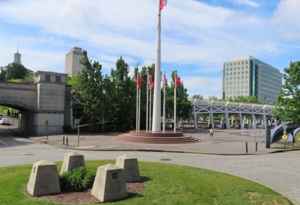 a flag pole in a park with flags flying in the wind, Bicentennial Capitol Mall State Park