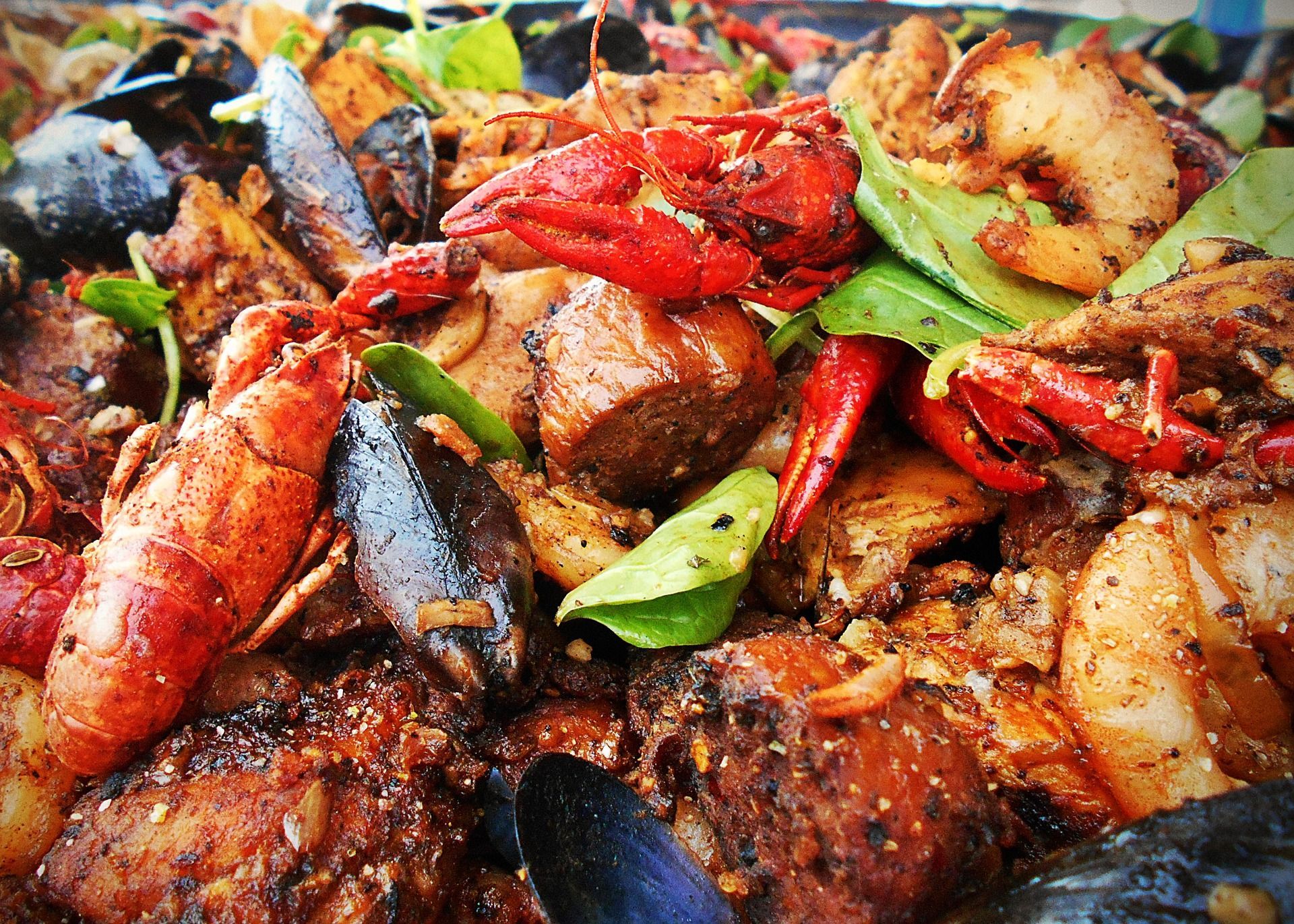 A close up of a plate of food with shrimp and lobsters