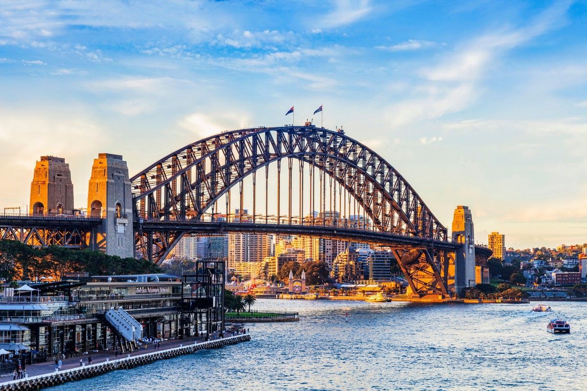 The sydney harbor bridge is a large bridge over a body of water on a world cruise