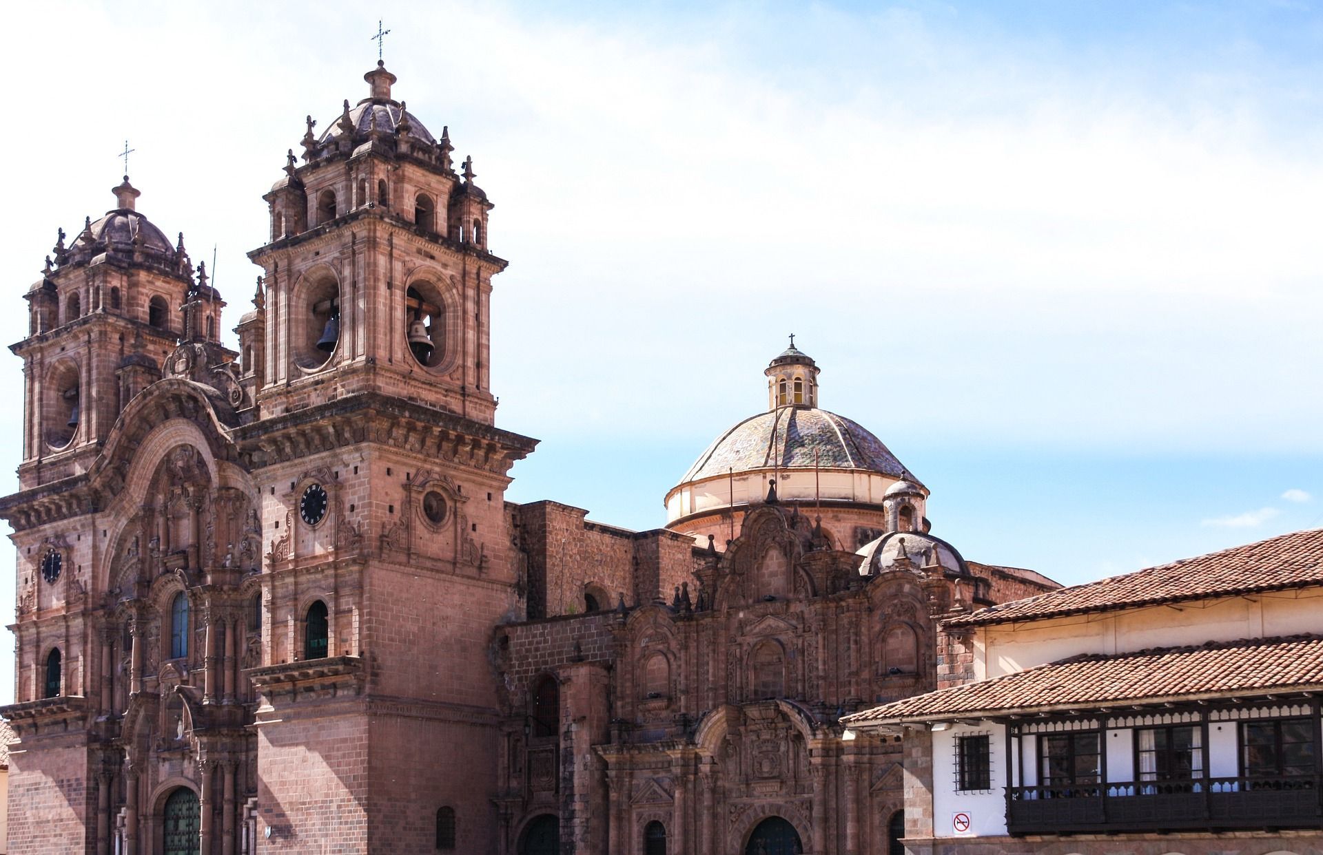 A large building with a dome on top of it the Cathedral on Plaza de Armas