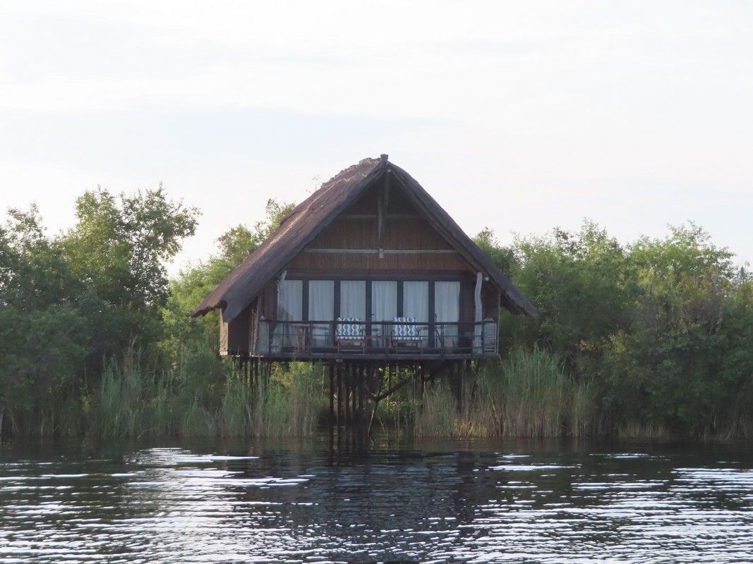 A small house on stilts in the middle of a lake