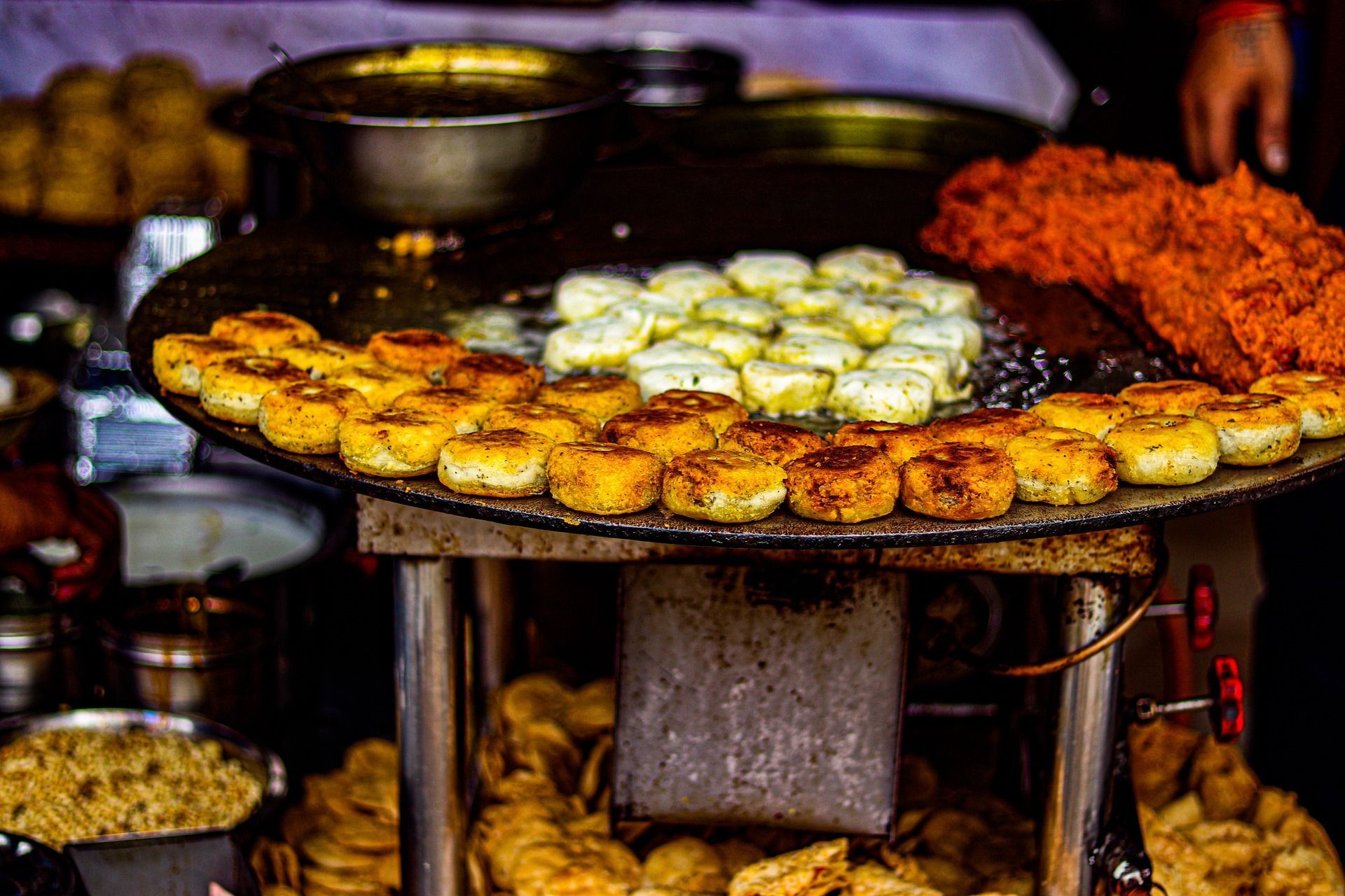 A person is cooking food on a stove in a restaurant.