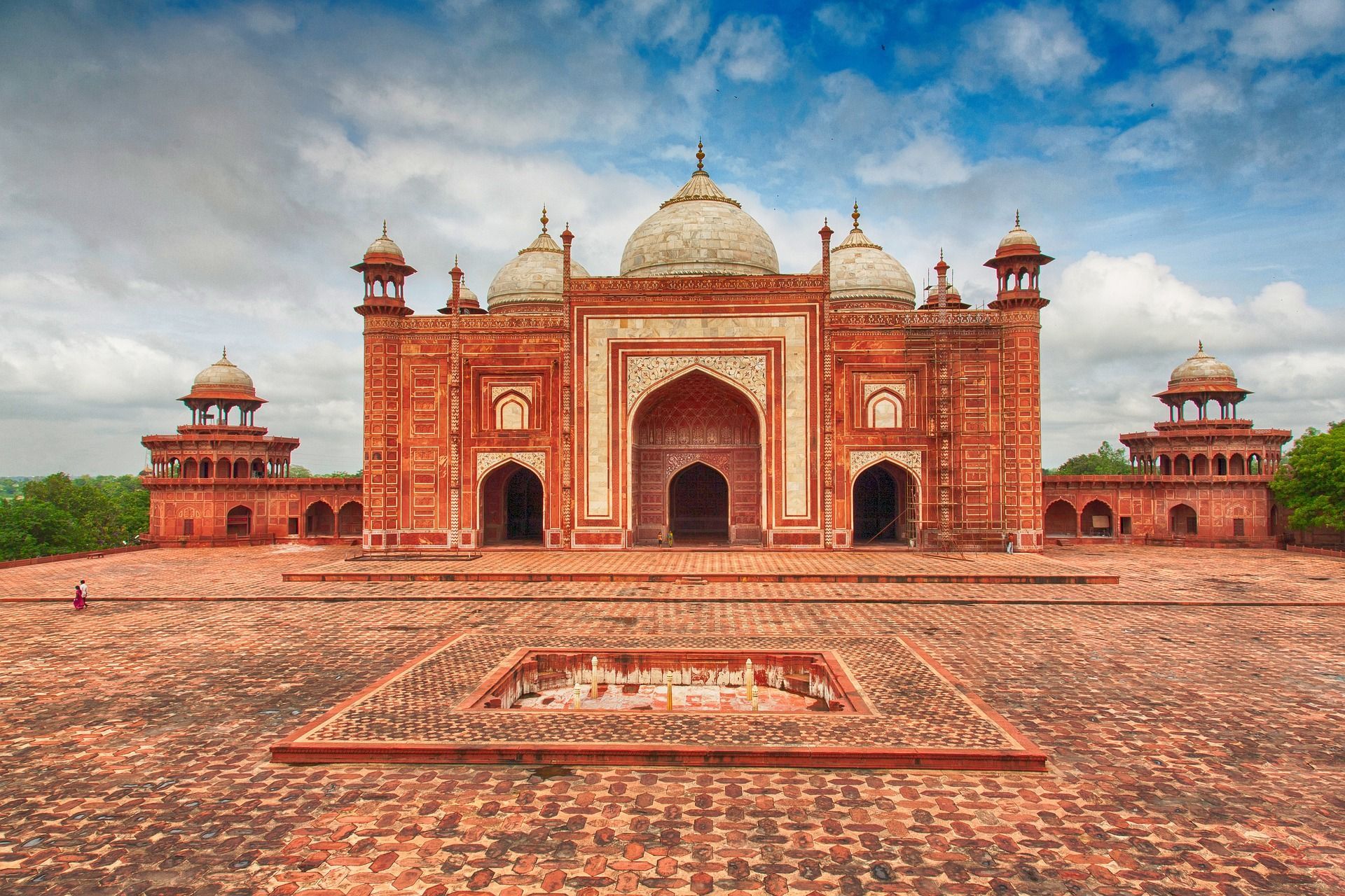 A large red brick building with a dome on top of it in India