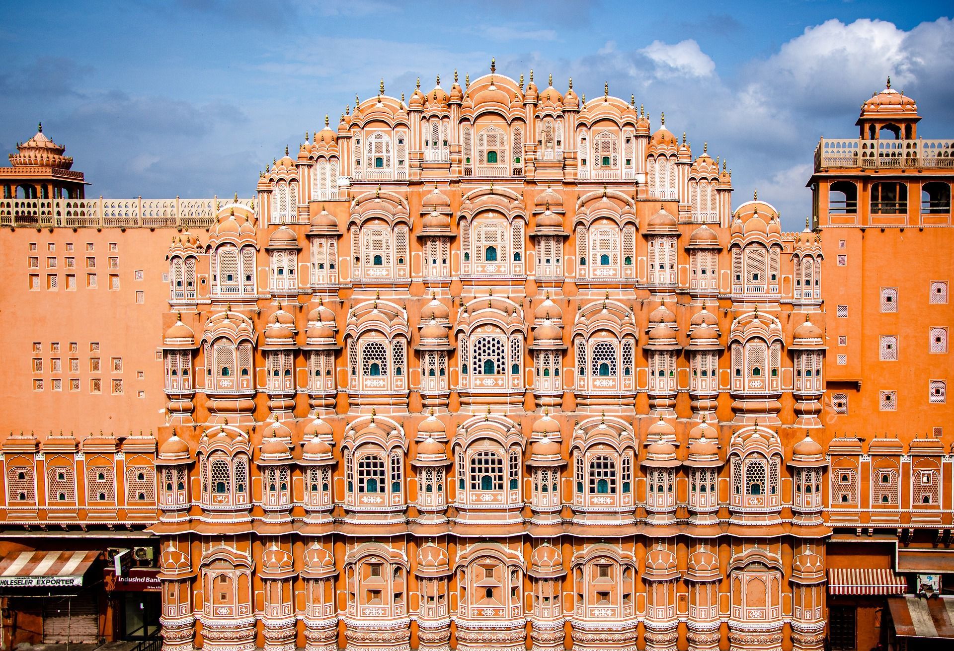 A large building with a lot of windows and a blue sky in the background.