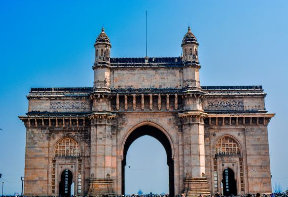 A large stone archway with a blue sky in the background