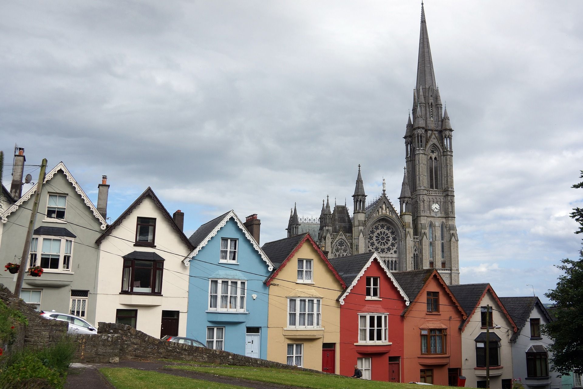 A row of houses with a church in the background