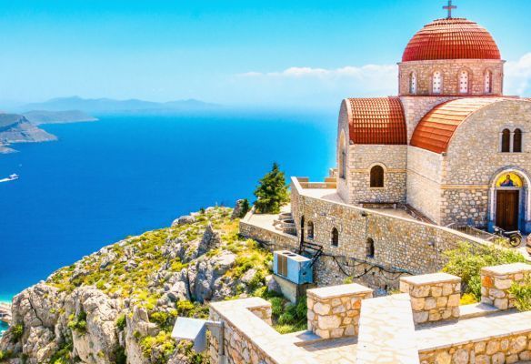 a church on top of a hill overlooking the ocean . Top Romantic Ports - Corfu