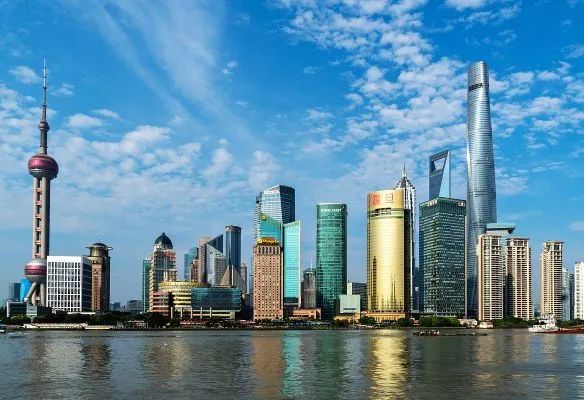 A city skyline with a large body of water in the foreground in China