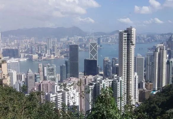 A city skyline with a lot of buildings and mountains in the background