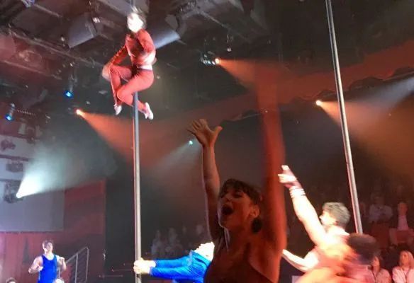 A group of people are performing aerial acrobatics on a stage