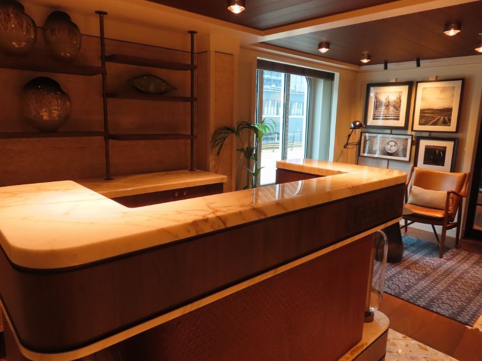 A room with a marble counter top and a chair