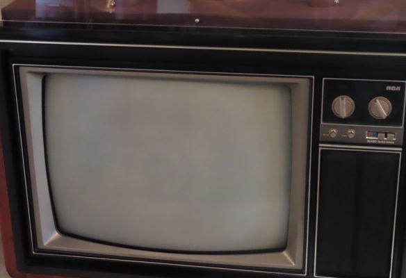 an old rca television is sitting on a table , One of many the TV’s that Elvis owned