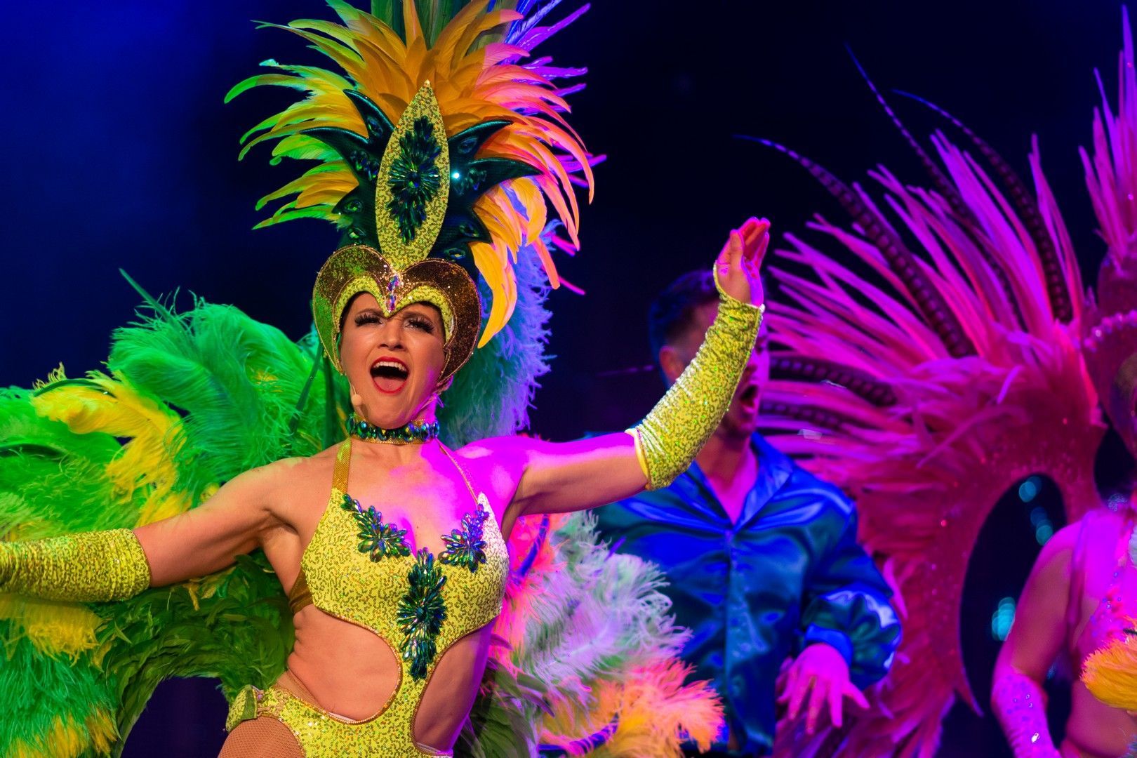 A woman in a colorful costume is dancing on a stage.