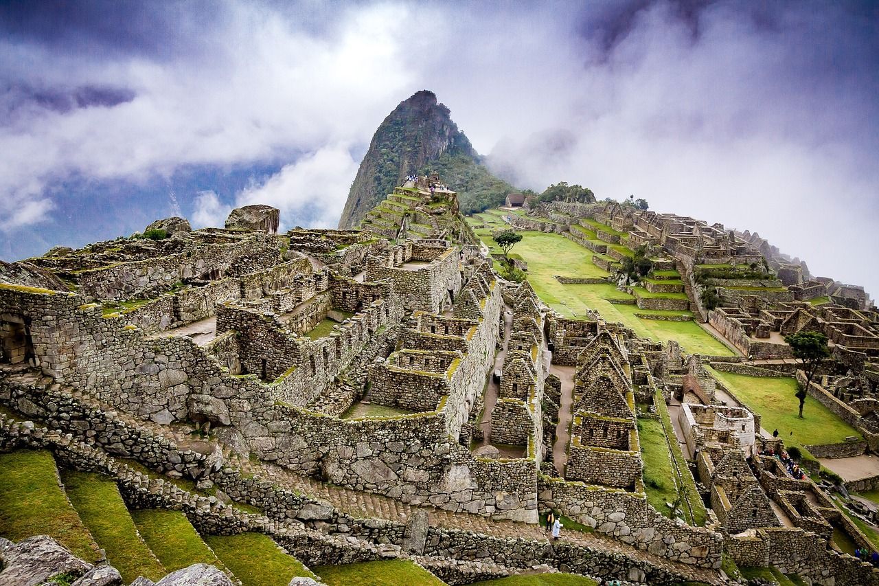 The ruins of the inca city of machu picchu are surrounded by a mountain.