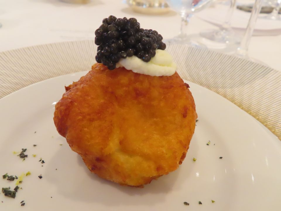 A close up of a plate of food with caviar on top