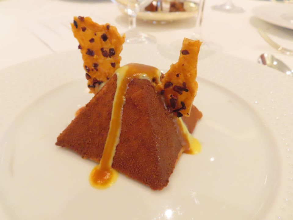 A close up of a dessert on a white plate on a table.