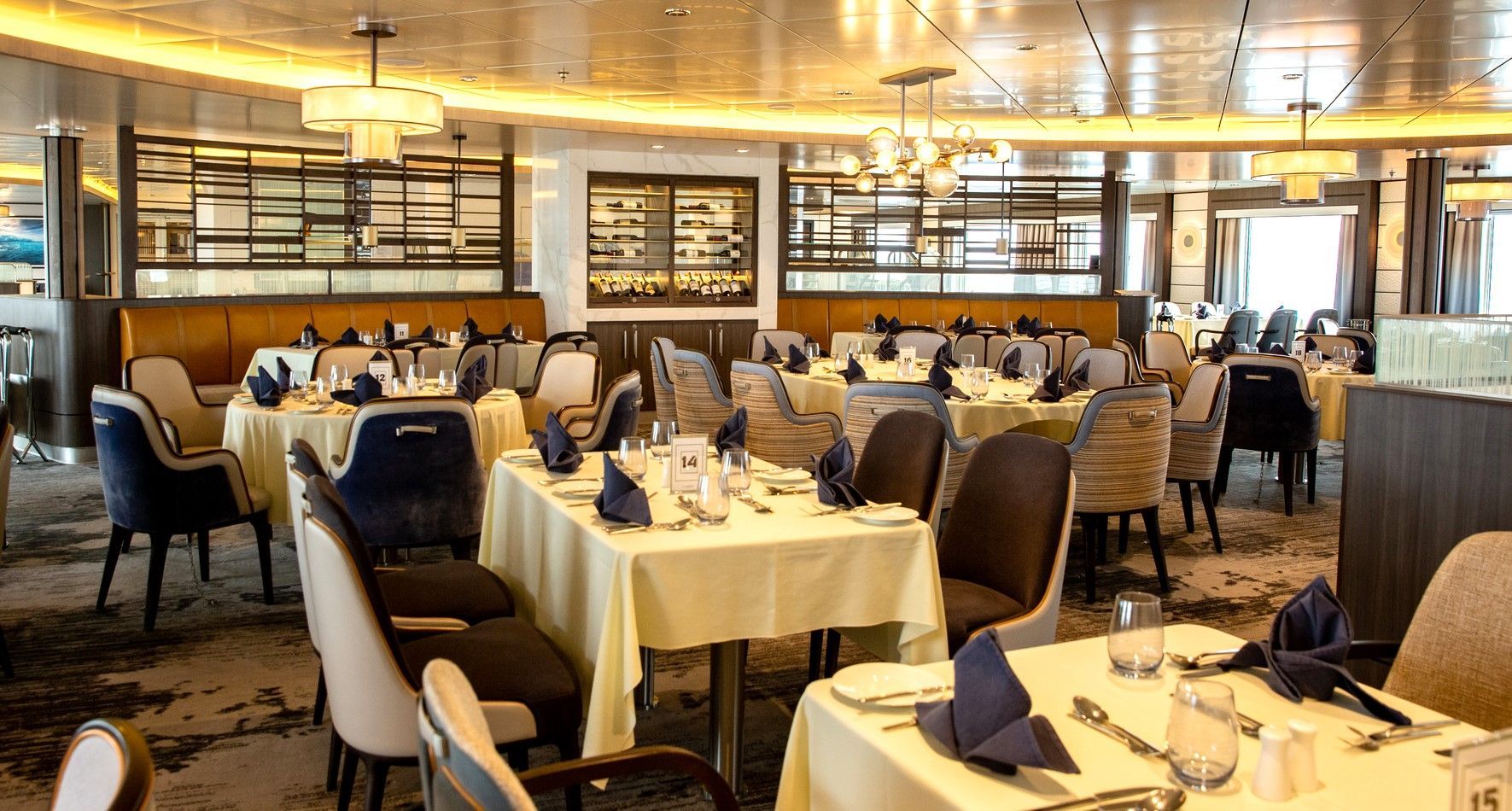 A large dining room filled with tables and chairs onboard expedition ship Sylvia Earle