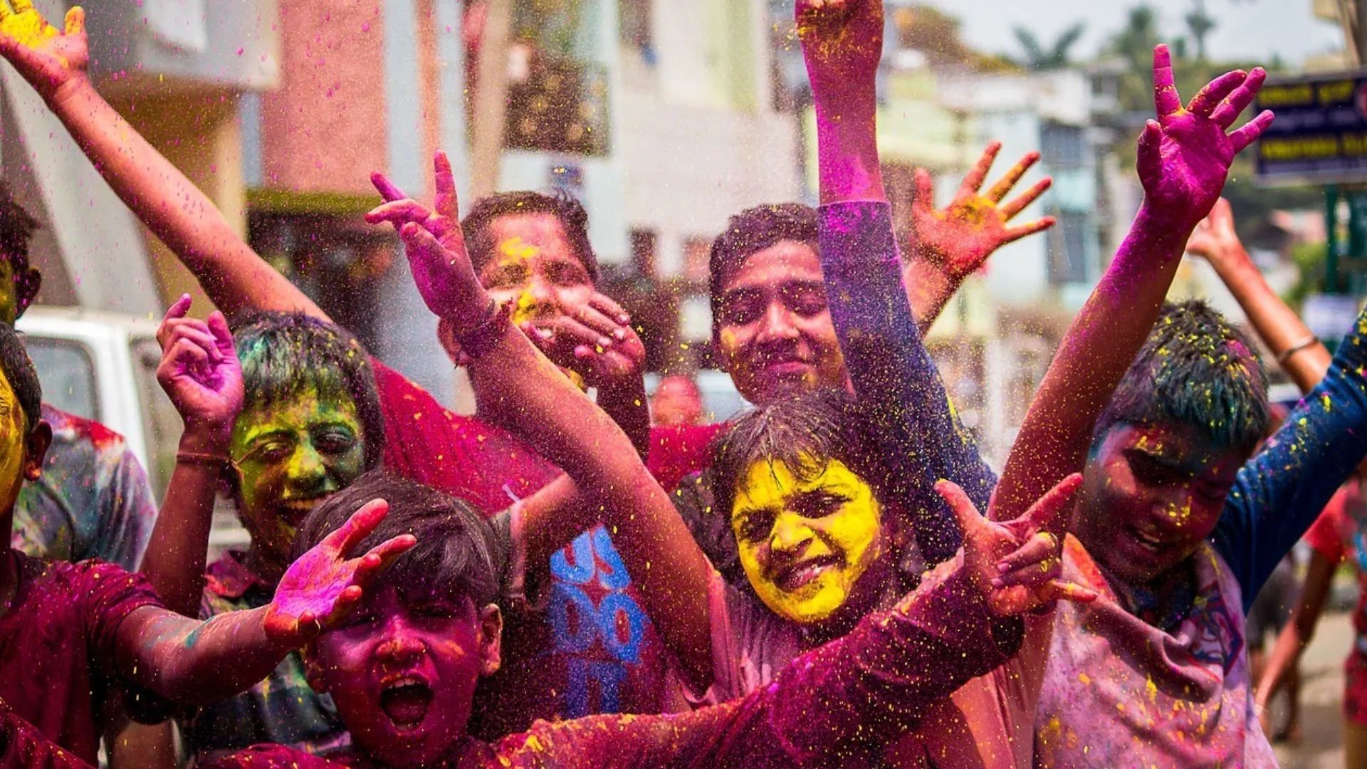 A group of children are playing with colored powder at the Holi festival, India