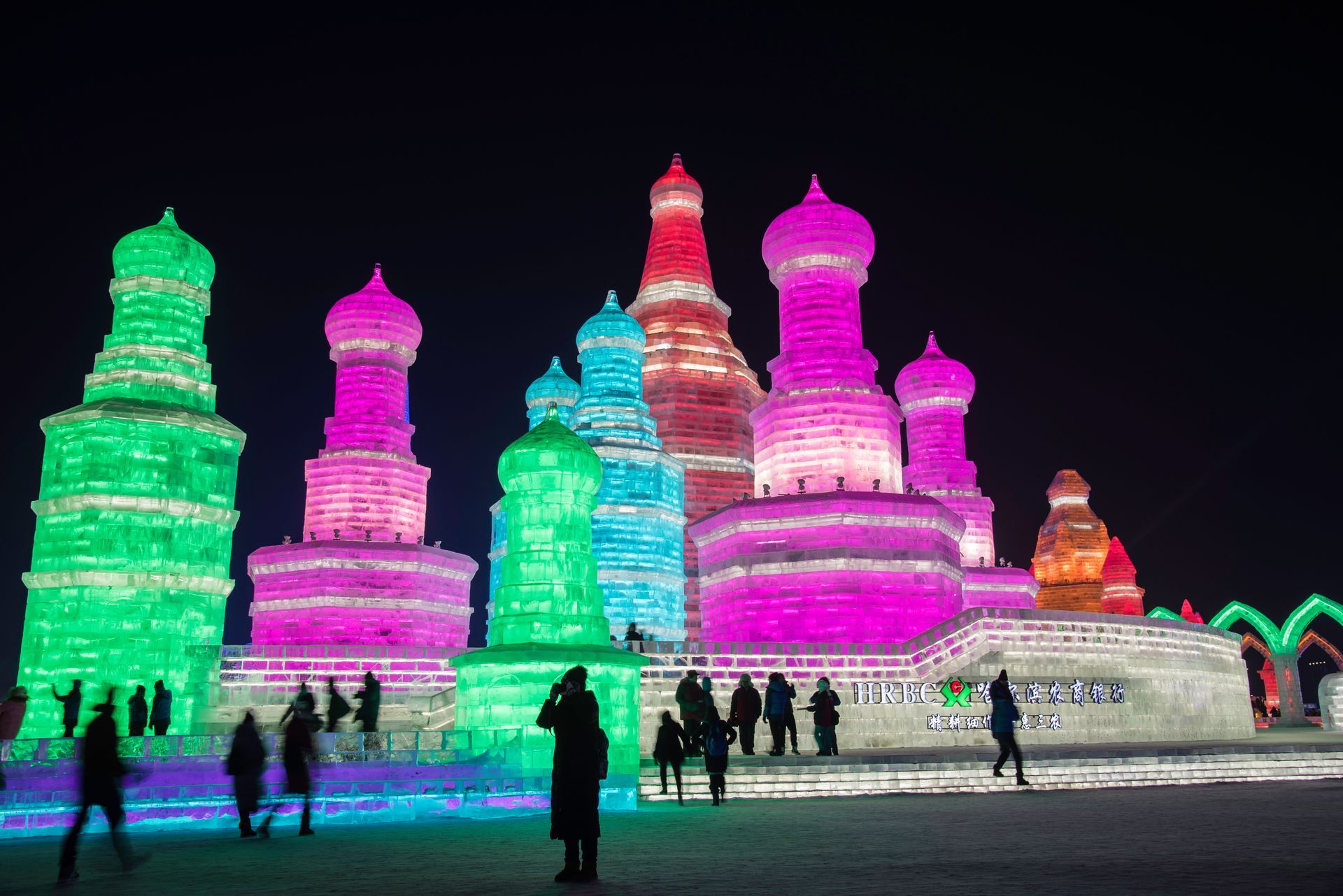 a large ice sculpture with chinese writing on it at Harbin International Ice and Snow Sculpture Festival