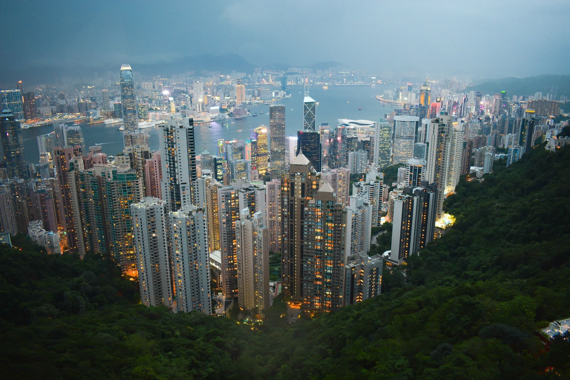 An aerial view of a city at night from a mountain in Hong Kong