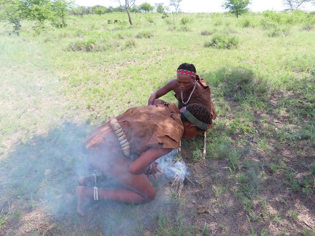 Two men in africa are making a fire