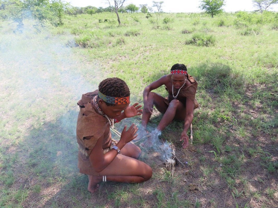 Two men in africa are making a fire