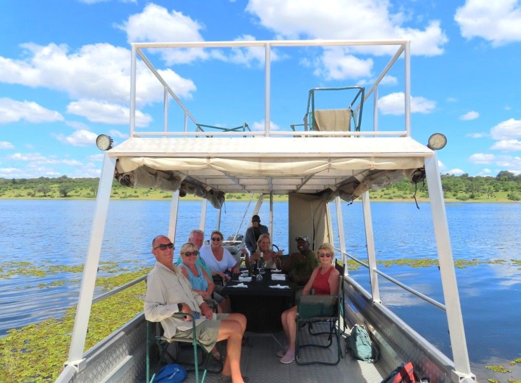 A group of people are sitting on a boat on a lake.