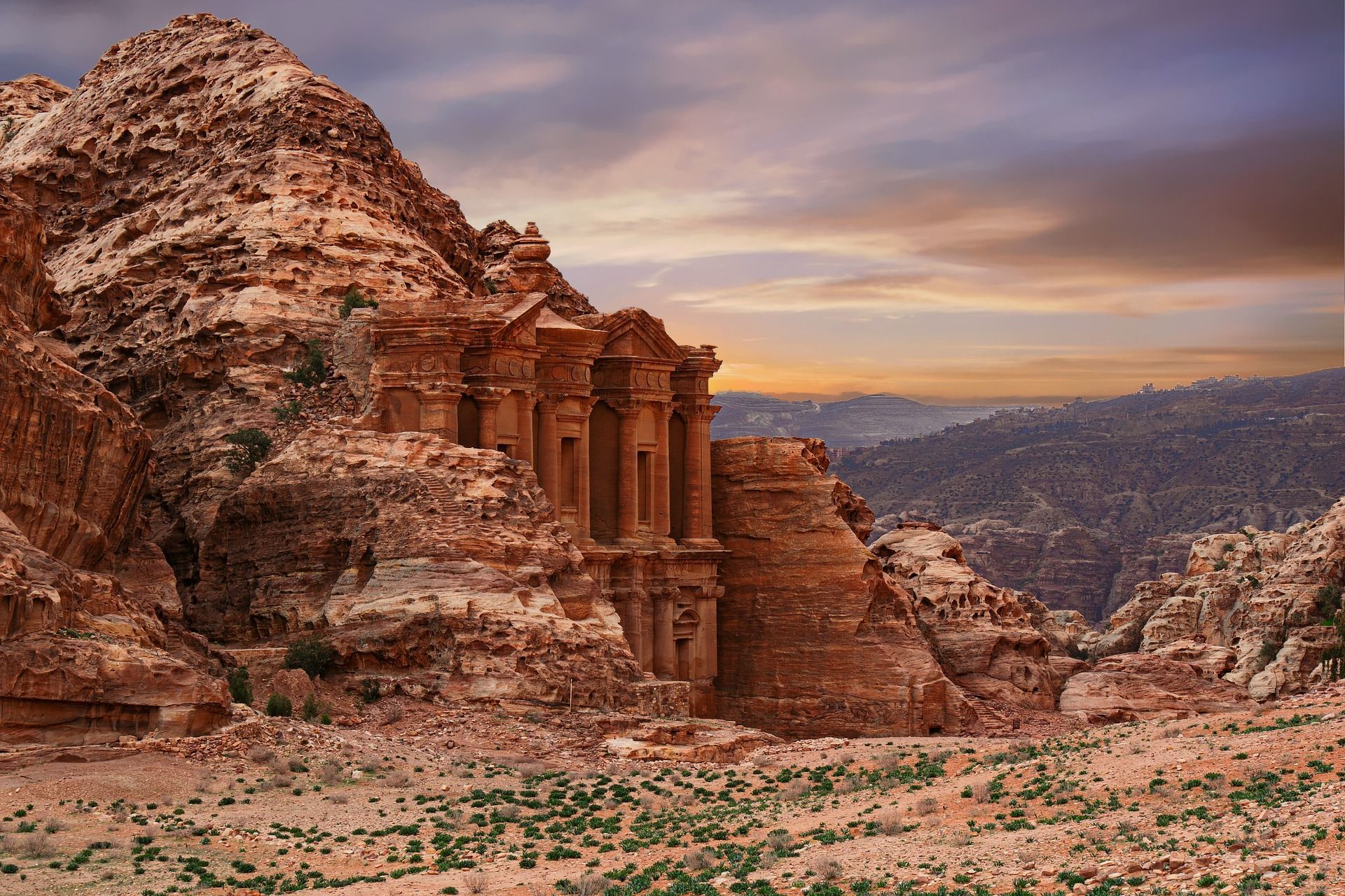A desert landscape with a building in the middle of it in Jordan