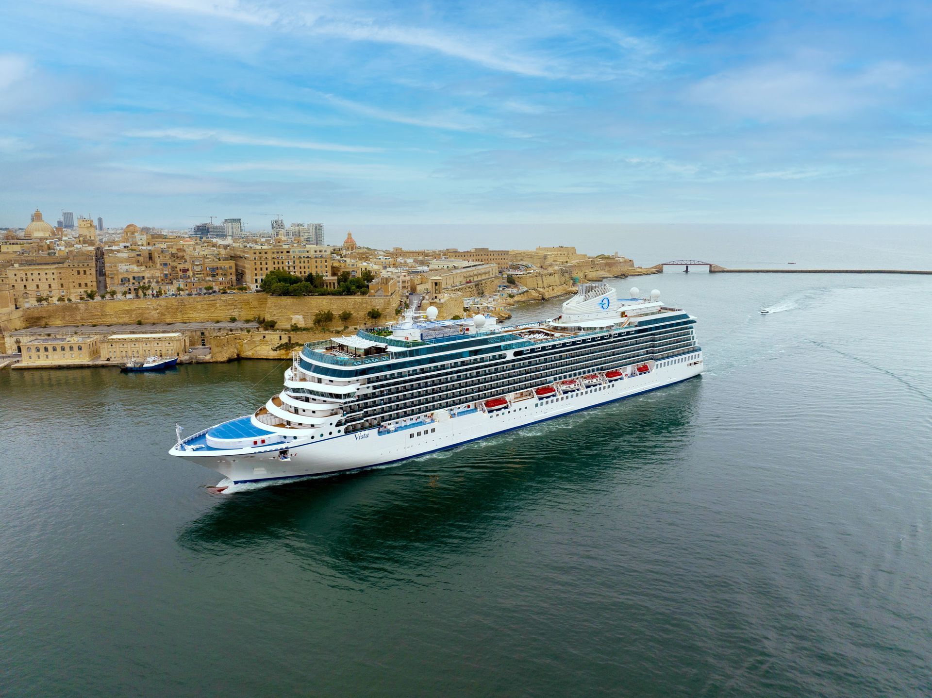 An aerial view of an Oceania cruise ship floating on top of a body of water.