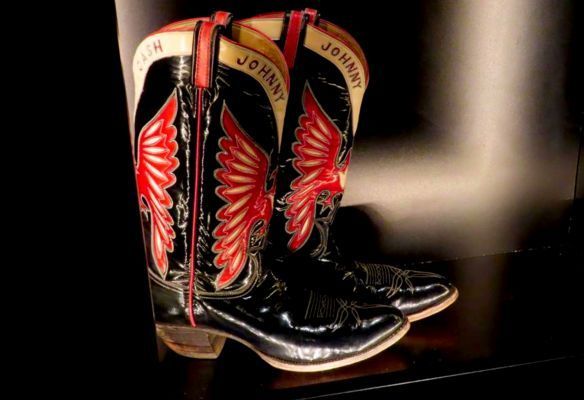 a pair of black and red cowboy boots are sitting on a shelf - Johnny Cash boots