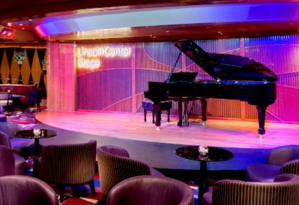 a piano is on a stage in a room with chairs  Lincoln Center Stage on MS Koningsdam