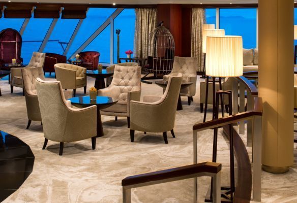 a large room with lots of chairs and tables called The Living Room on Azamara Quest