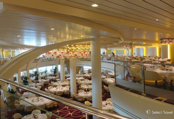 a large dining room with tables and chairs on a cruise ship Main Restaurant on MS Koningsdam