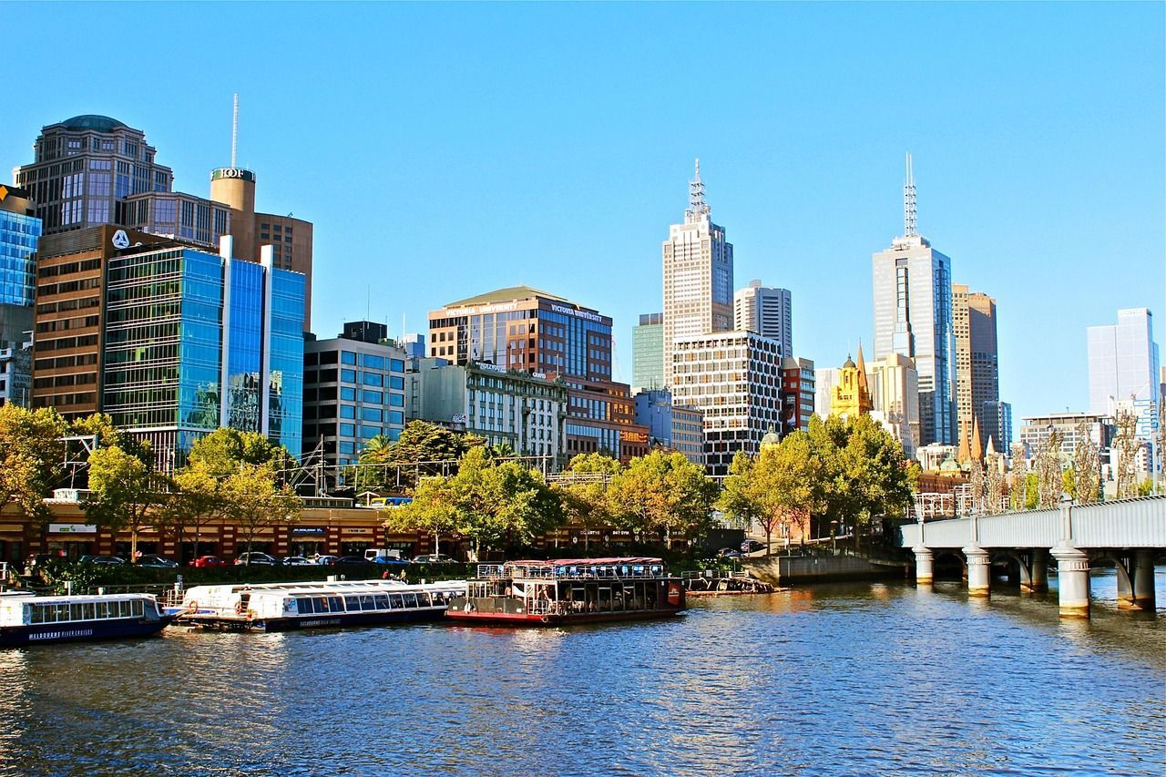 A city skyline with a river in the foreground