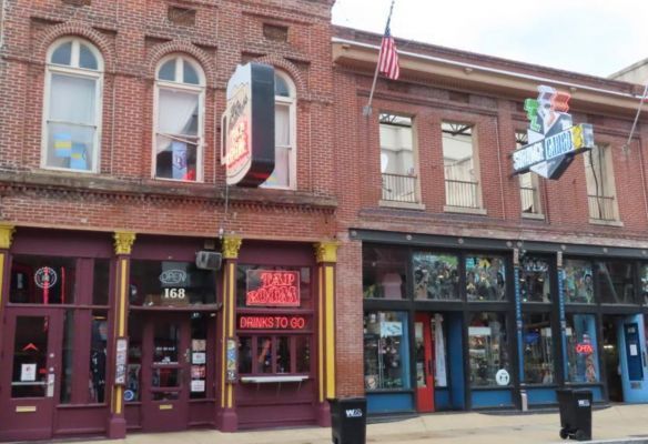 a brick building with a sign that says drinks to go in Memphis