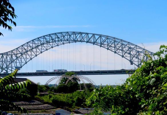 Memphis river views on the Mississippi a bridge over a body of water with a blue sky in the background .