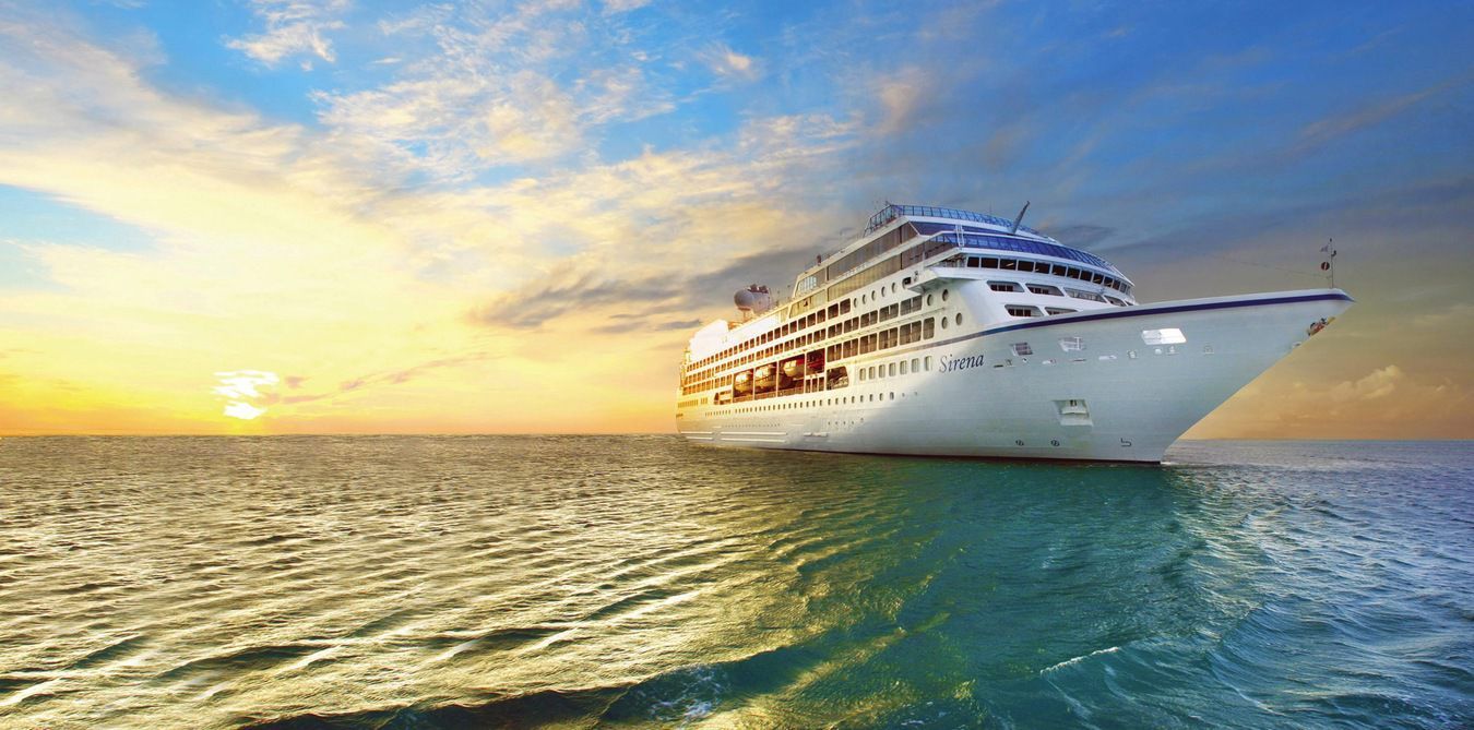 A cruise ship is floating on top of a large body of water with oceania written on it