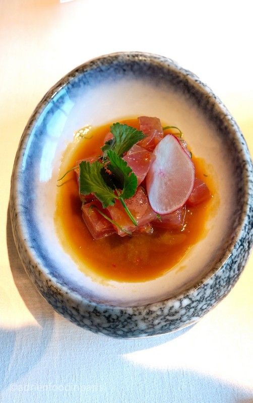 A close up of a bowl of nikkei food on a table.