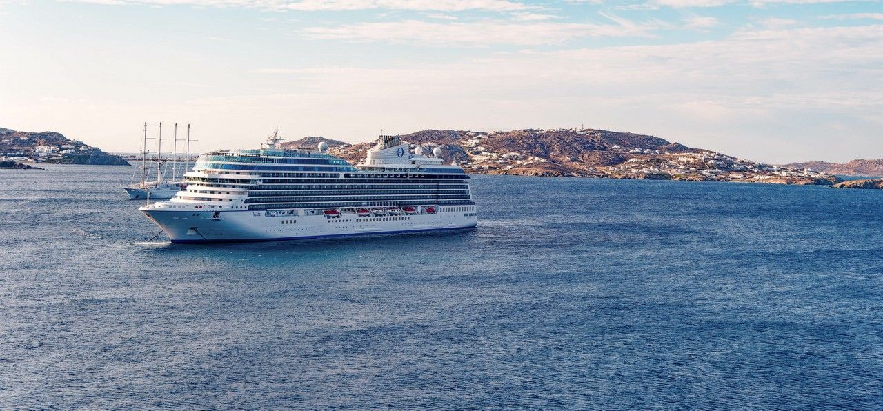 An oceania cruise ship is floating on the sea on a world cruise.