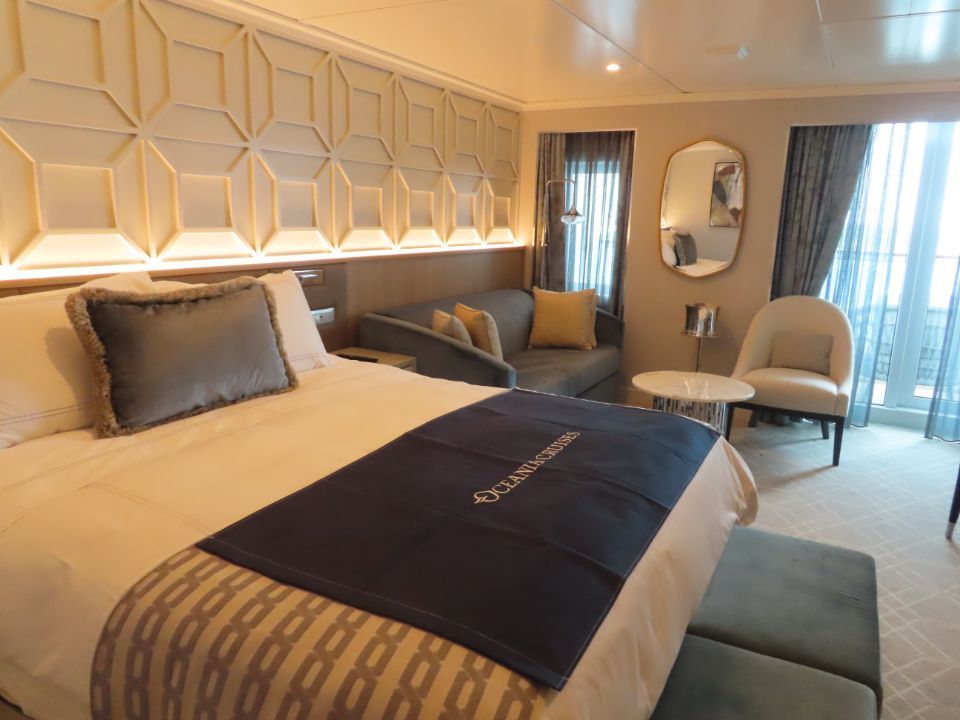 A cruise room with a large bed and a couch