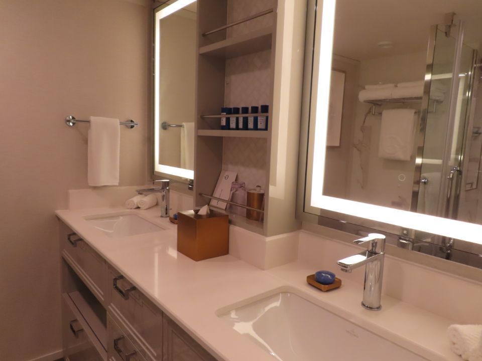 A bathroom with two sinks and two mirrors.