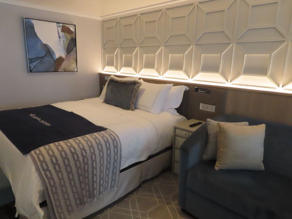 A cruise room with a bed and a couch