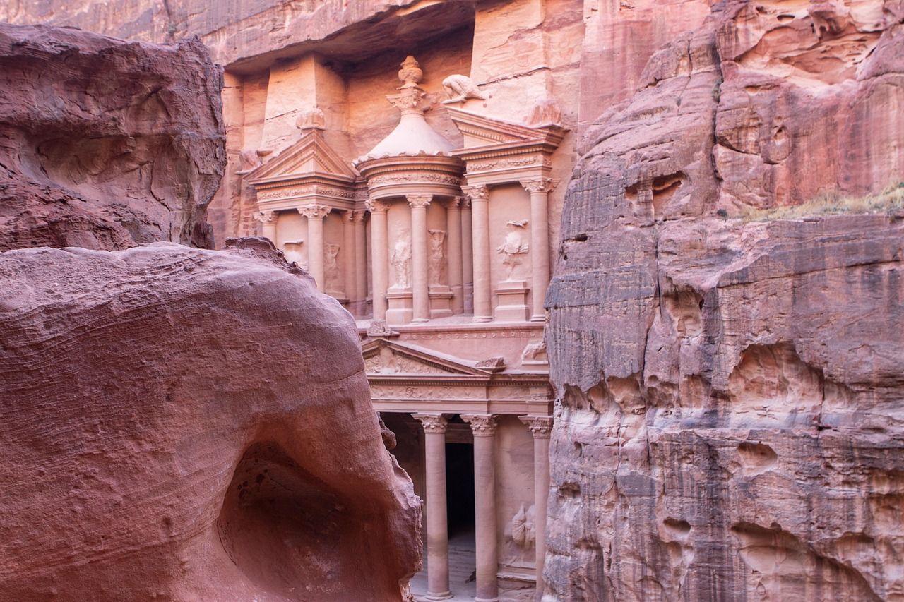 A building in the middle of a canyon surrounded by rocks at petra on the Silversea World Cruise 2028