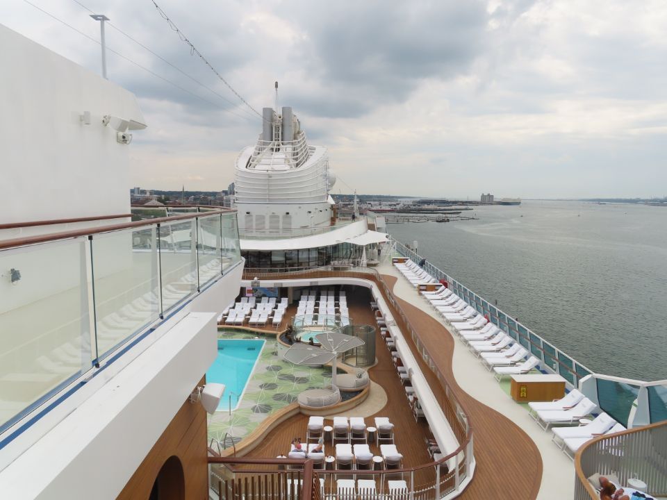 A large cruise ship with a swimming pool on the deck